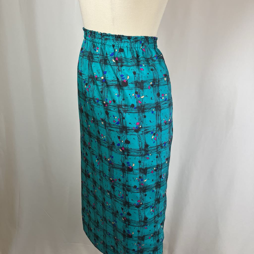 Teal skirt with black abstract pattern on a mannequin against a plain background