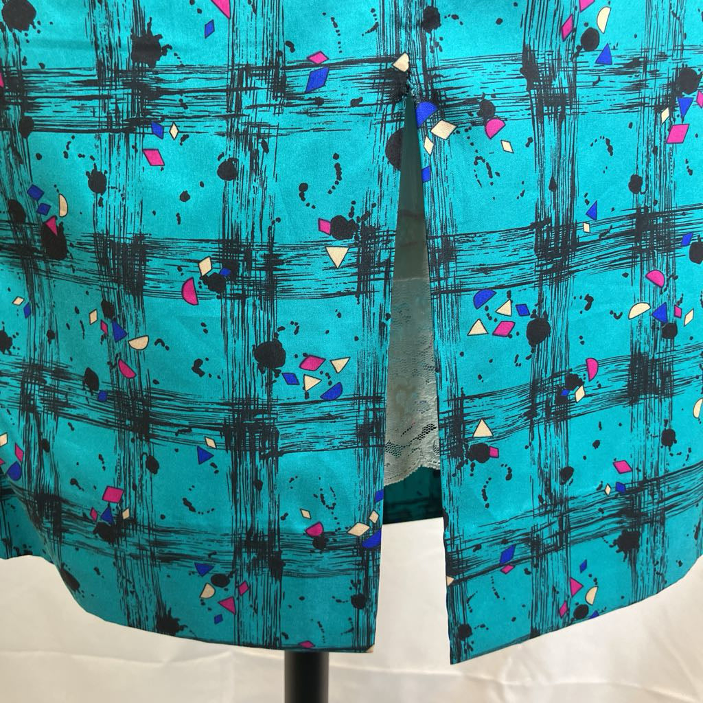 Blue fabric with black abstract patterns and colorful shapes on a white background