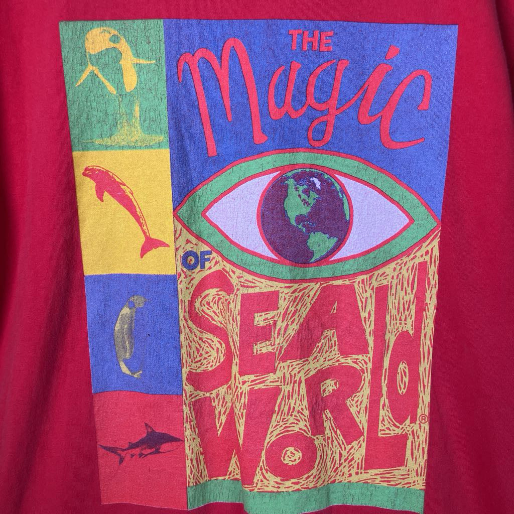 Vintage-style graphic t-shirt with colorful design and text on a red background