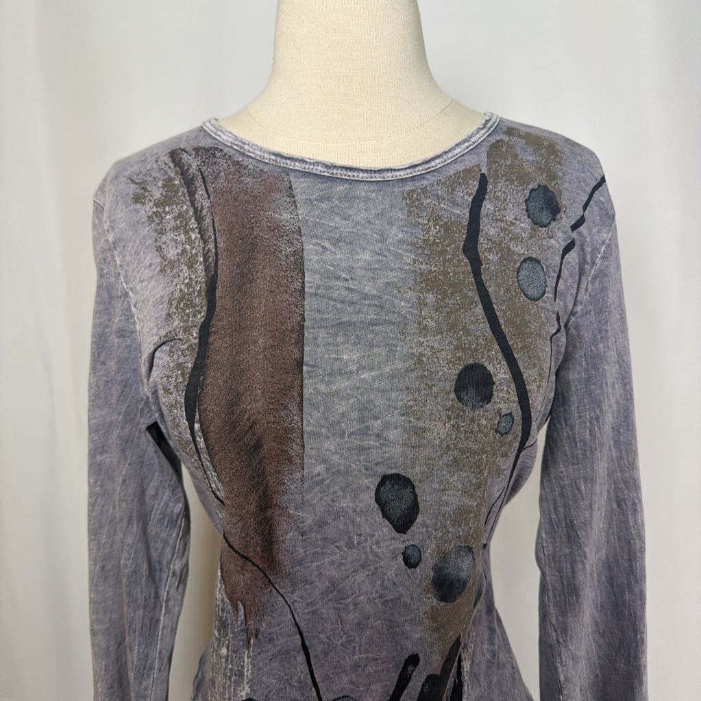 Gray tunic dress with an abstract design on a mannequin in front of a white wall.