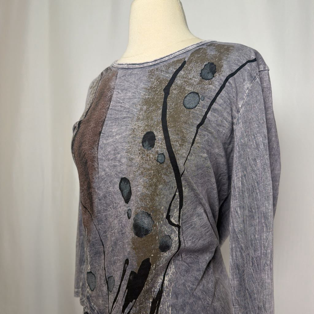 Gray tunic dress with an abstract design on a mannequin in front of a white wall.
