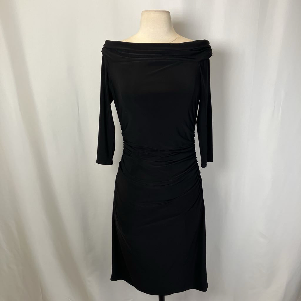 Black off-shoulder dress on a mannequin against a white background