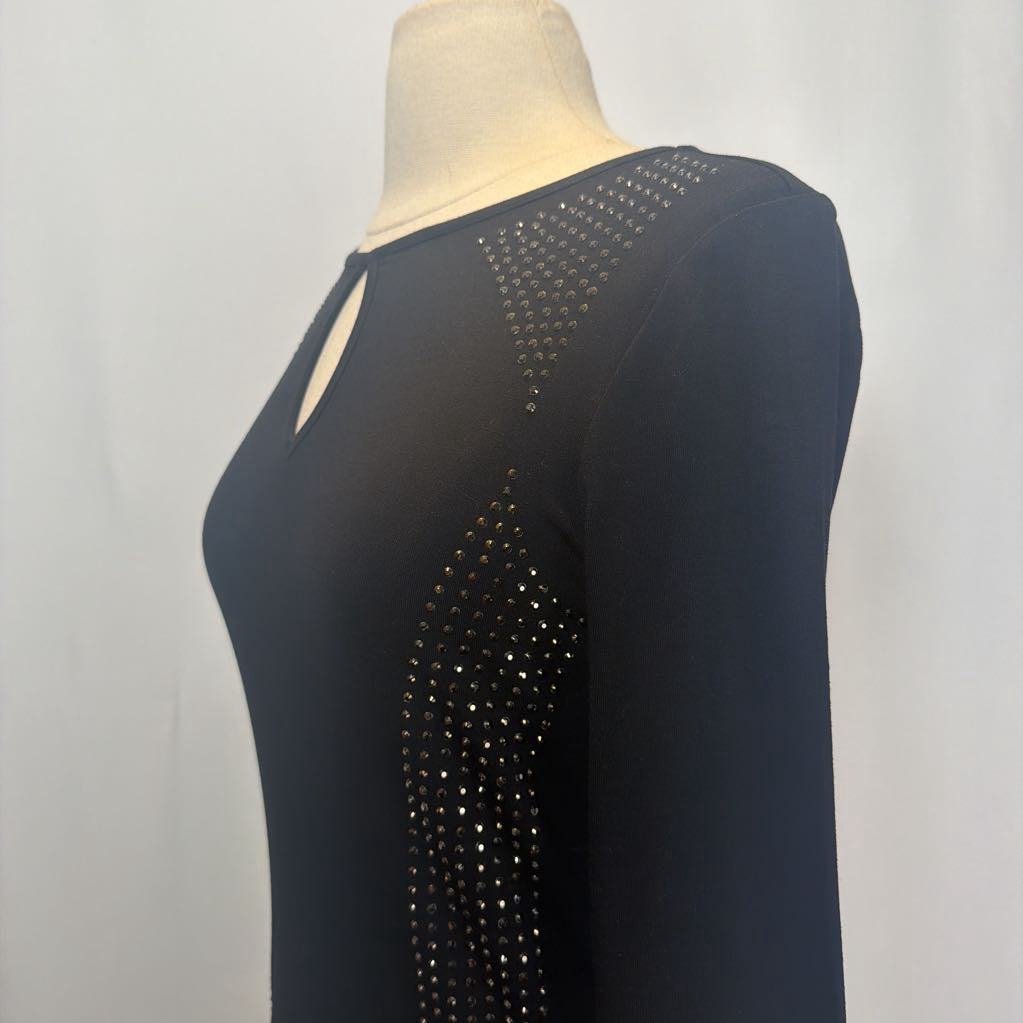 Black dress with rhinestone embellishments on a mannequin in front of a white wall.