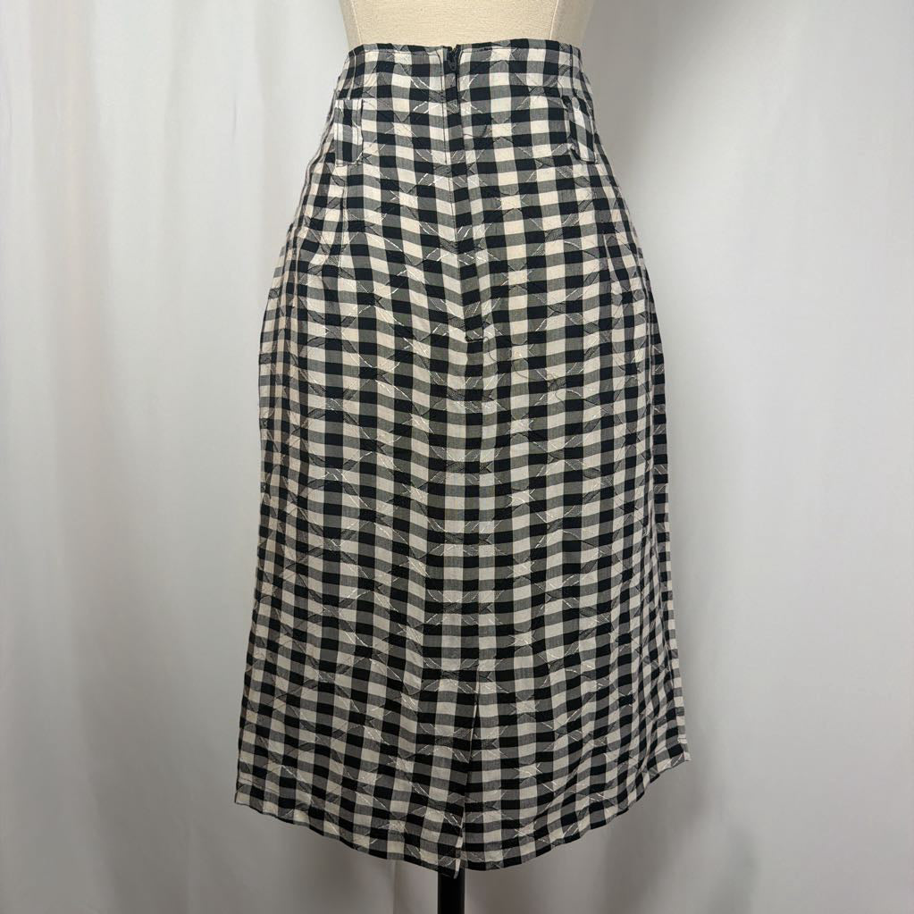 Black and white gingham skirt on a mannequin front of a white wall.
