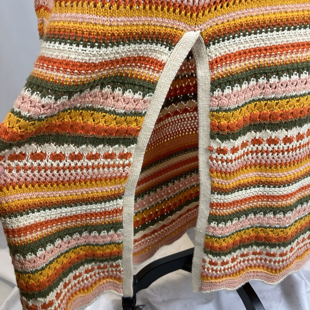 Colorful striped knitted cardigan on a chair