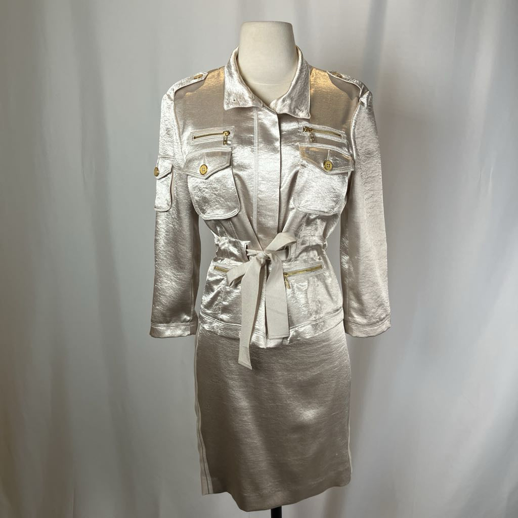 Silver metallic jacket and skirt set on a mannequin against a plain background