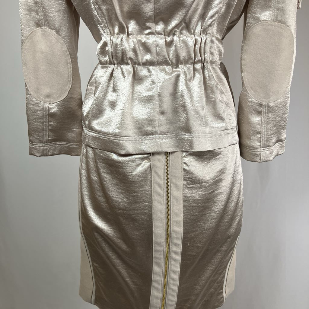 Silver metallic outfit with elbow pads on a gray background
