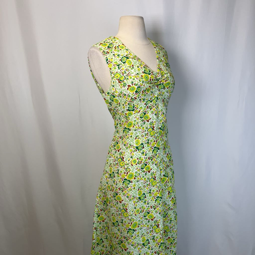 Floral dress on a mannequin against a plain background