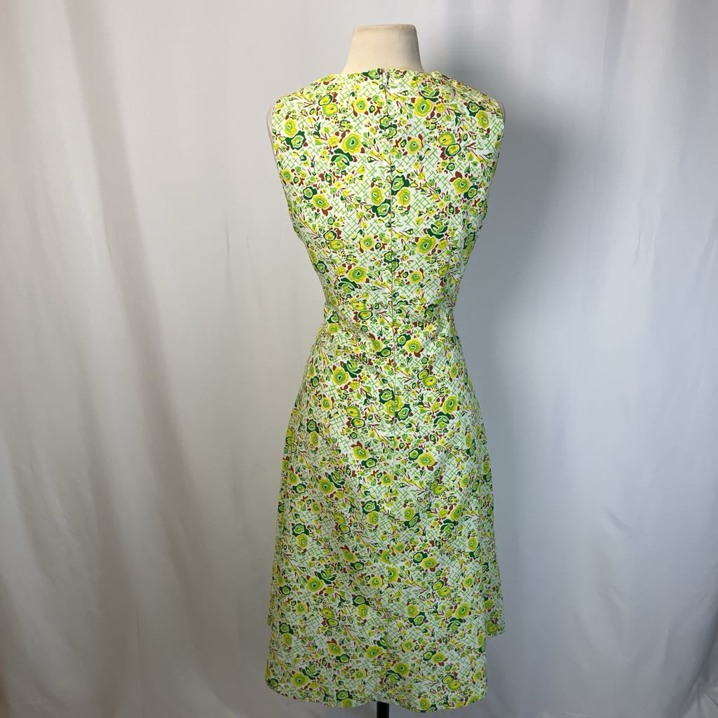 Floral dress on a mannequin against a plain background