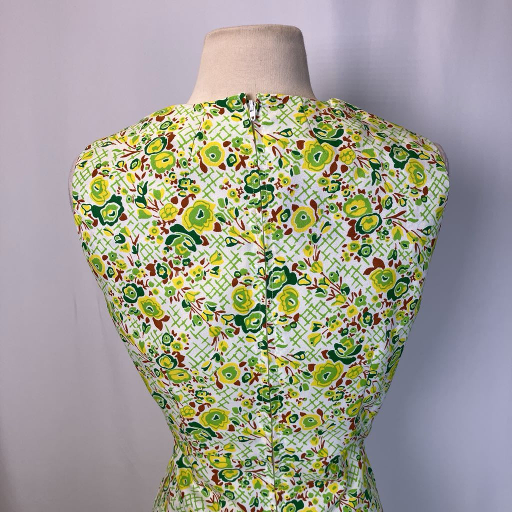 Mannequin wearing a floral patterned dress against a plain background