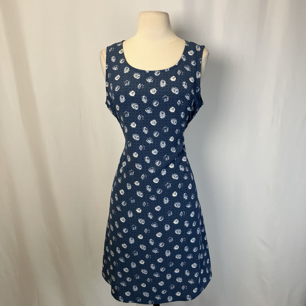 Blue dress with white floral pattern on a mannequin against a plain background
