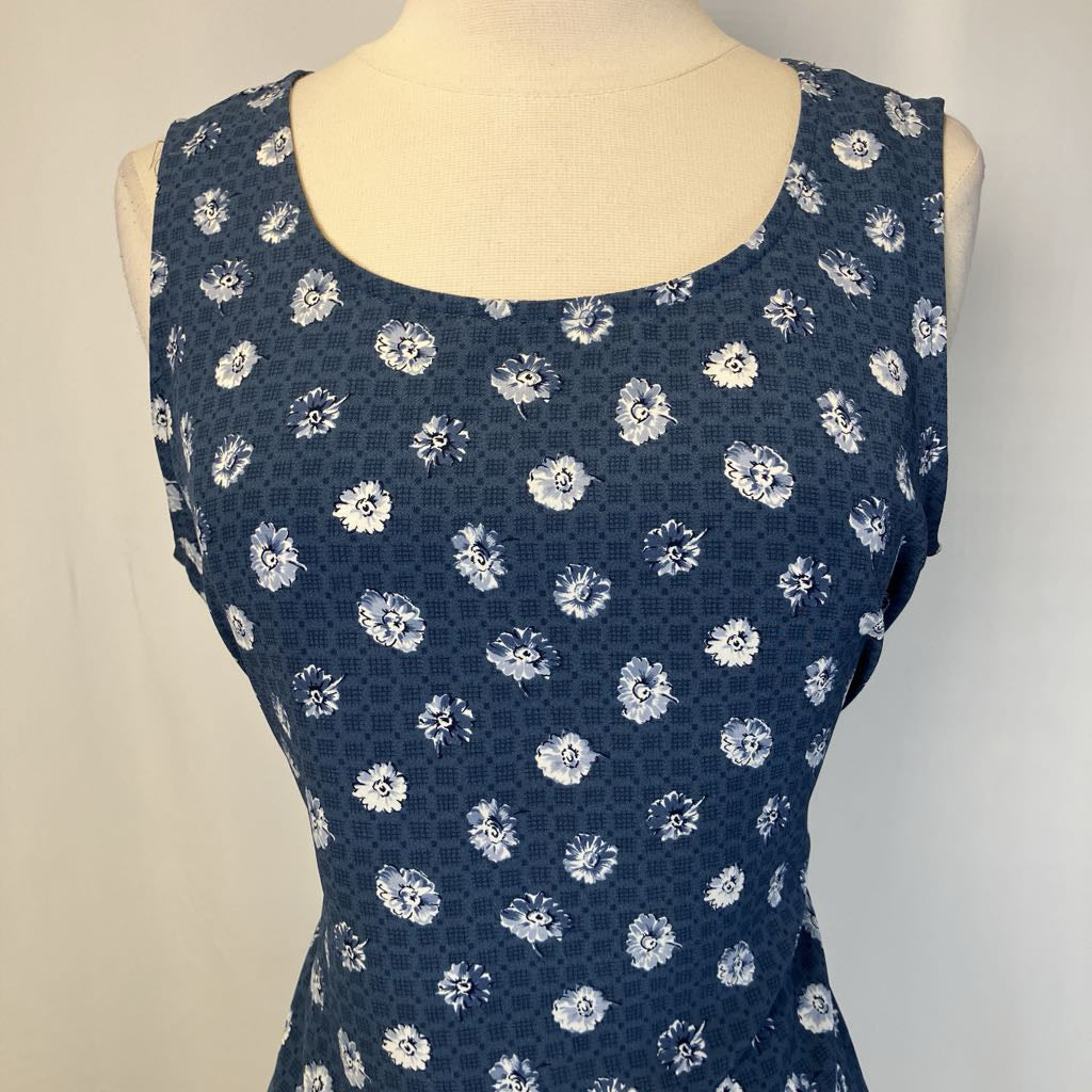 Blue dress with white floral pattern on a mannequin against a neutral background