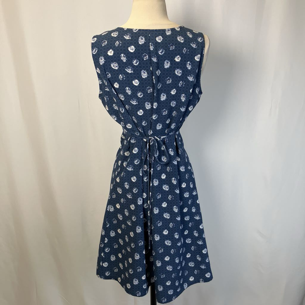 Navy blue dress with white floral pattern on a mannequin against a plain background