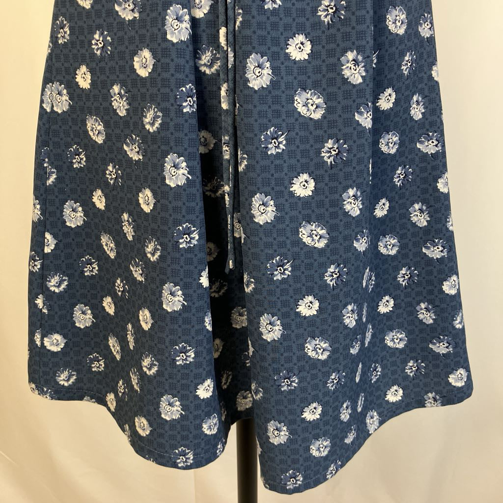 Blue dress with white floral pattern on a beige background
