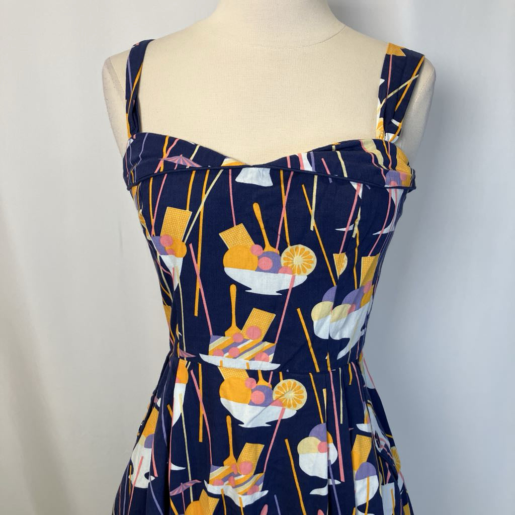Navy dress with colorful abstract pattern on a mannequin against a plain background
