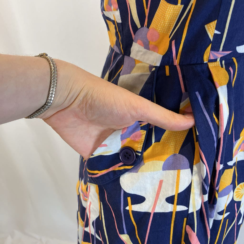 Closeup of the pocket on the side of the dress with simple white background