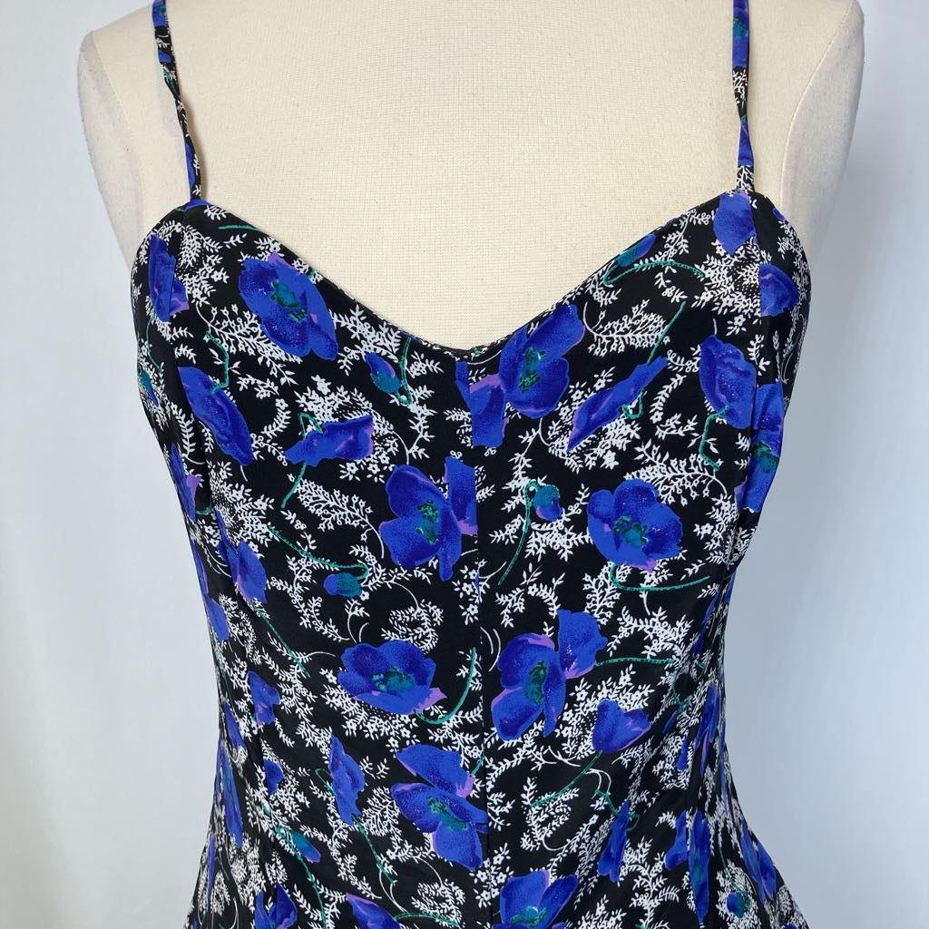 Close up of the neckline of the blue and black dress on simple background