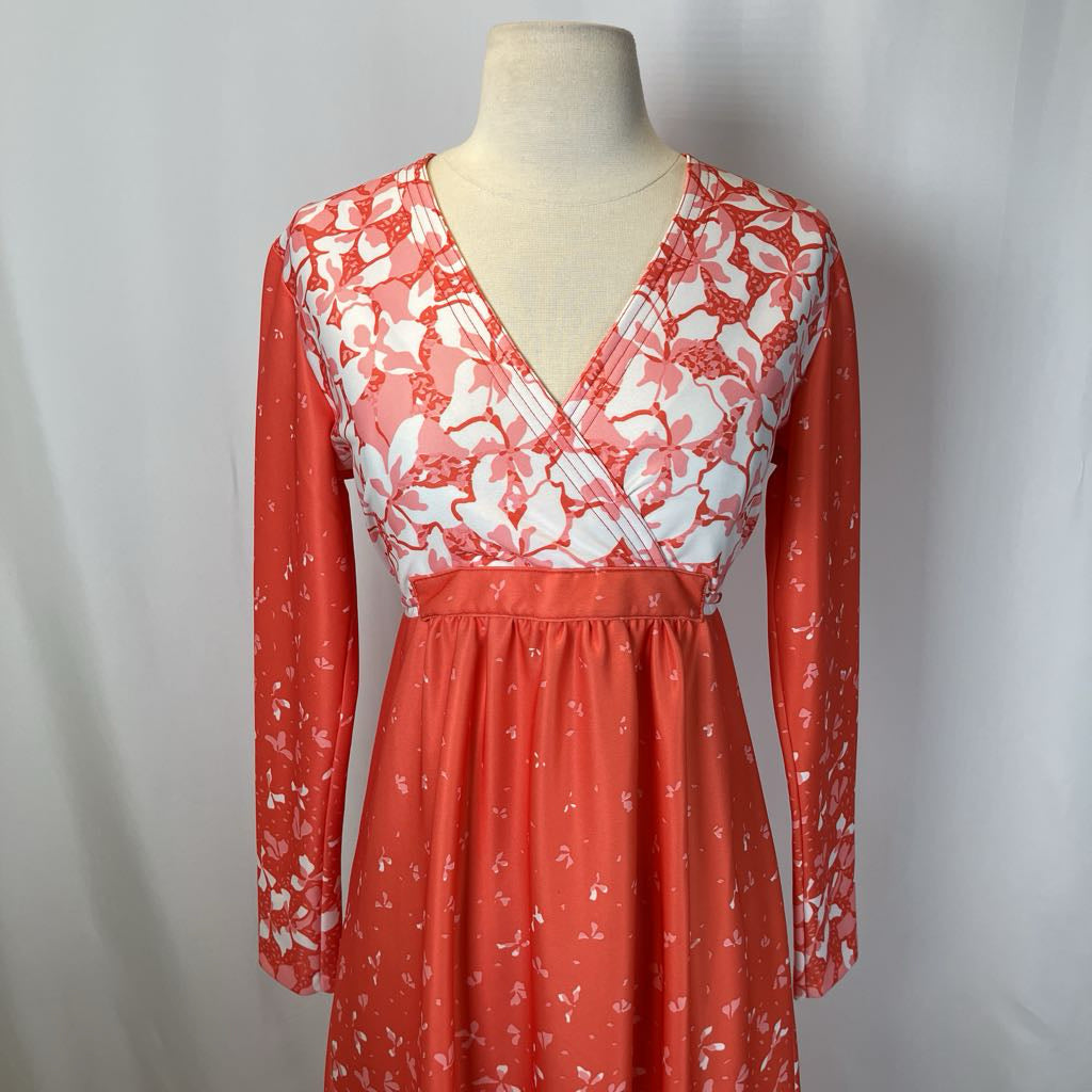 Red and white floral dress on a mannequin against a plain background