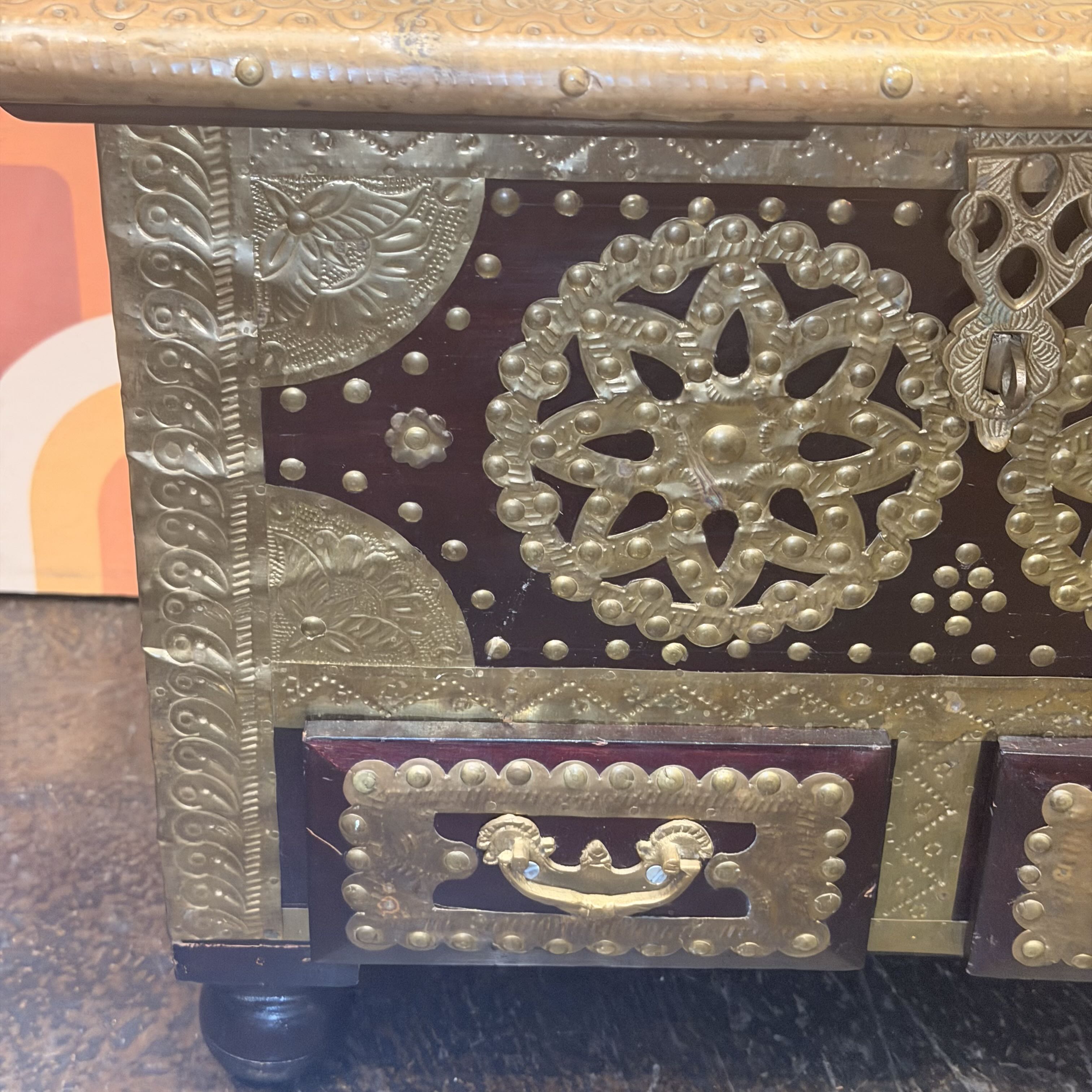 Decorative metal box with intricate patterns and designs.