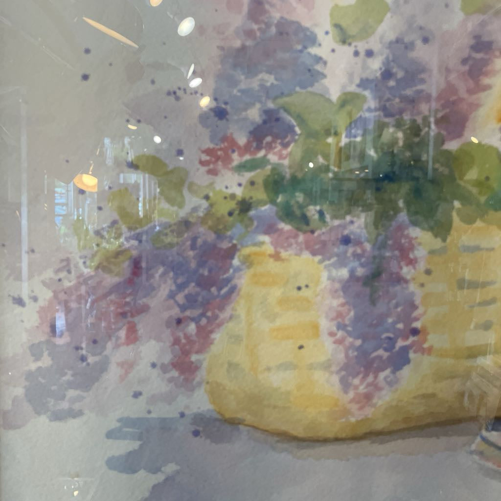 Colorful abstract painting of flowers in a yellow basket.