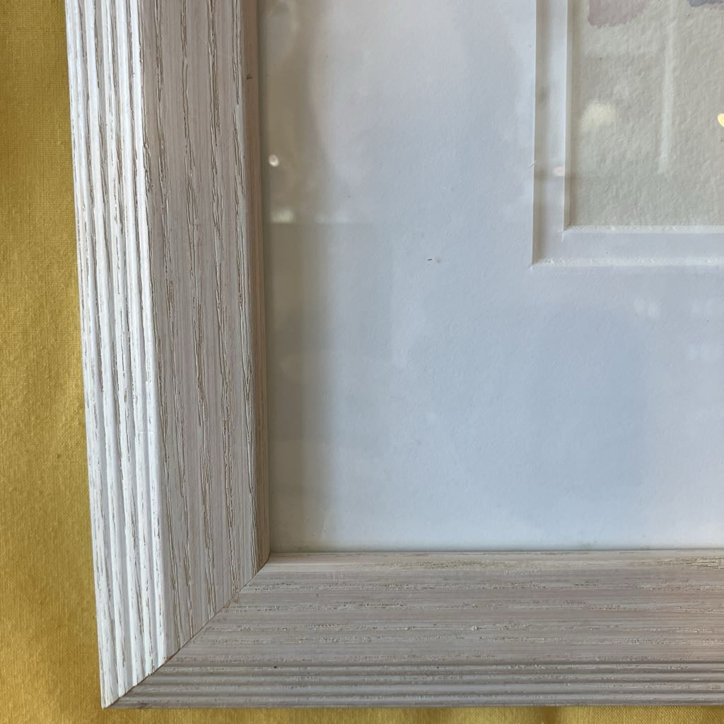 Close-up of a wooden picture frame corner on a yellow background