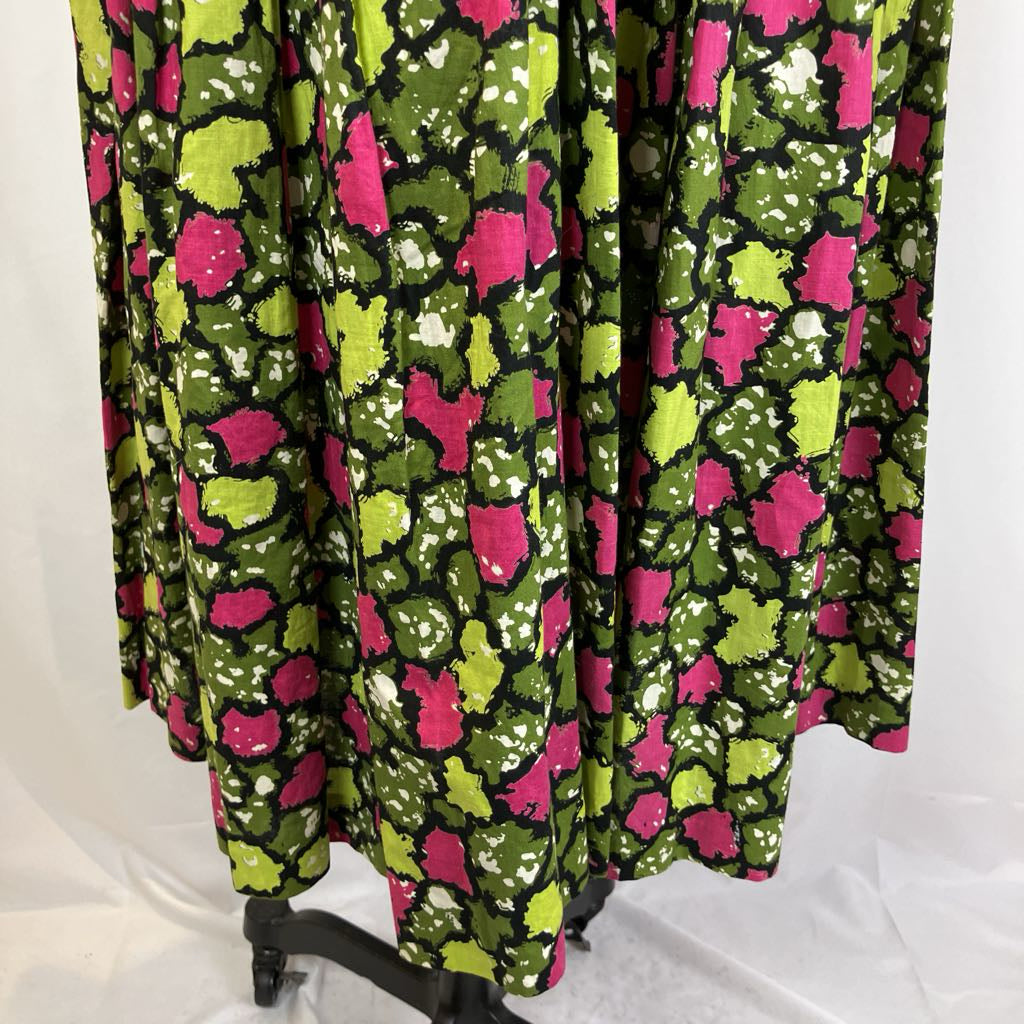 Colorful patterned curtain with pink and green design on a white background