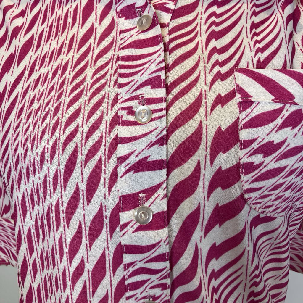 Close-up of a shirt with a zebra pattern in red and white.