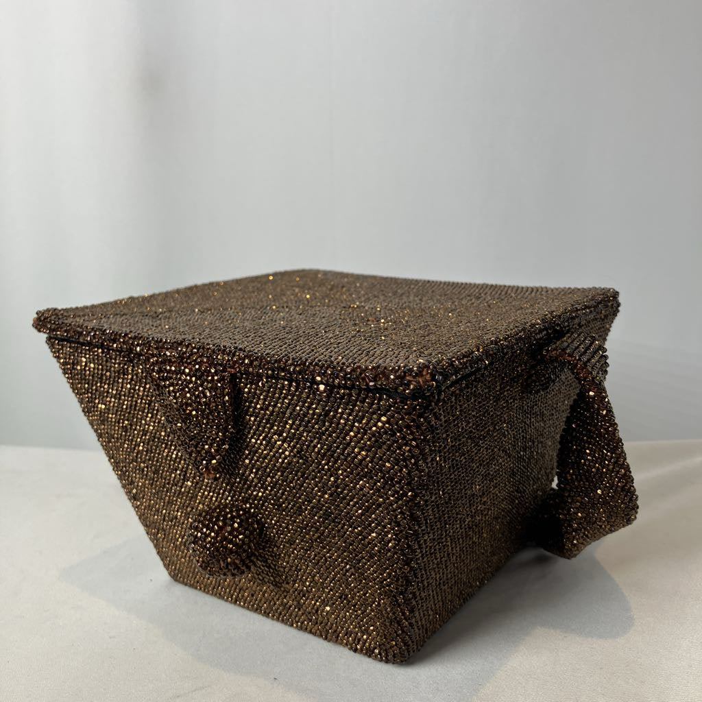 Brown beaded box on a light gray background