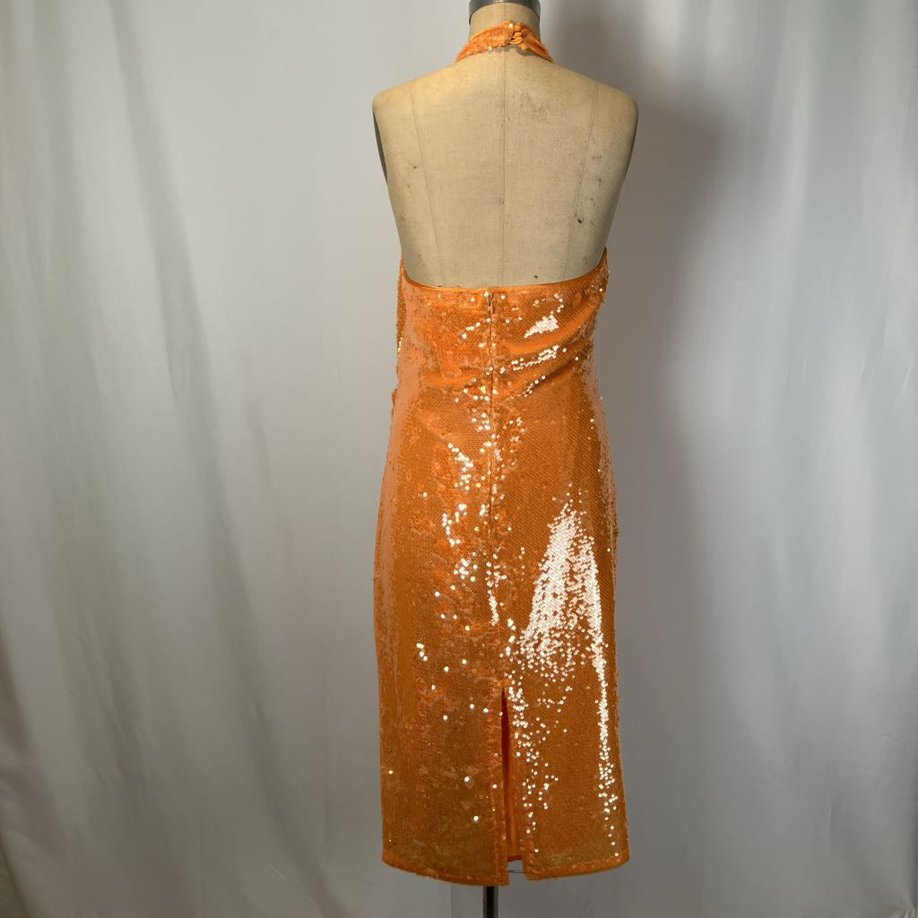 Orange sequin dress on a mannequin against a plain background