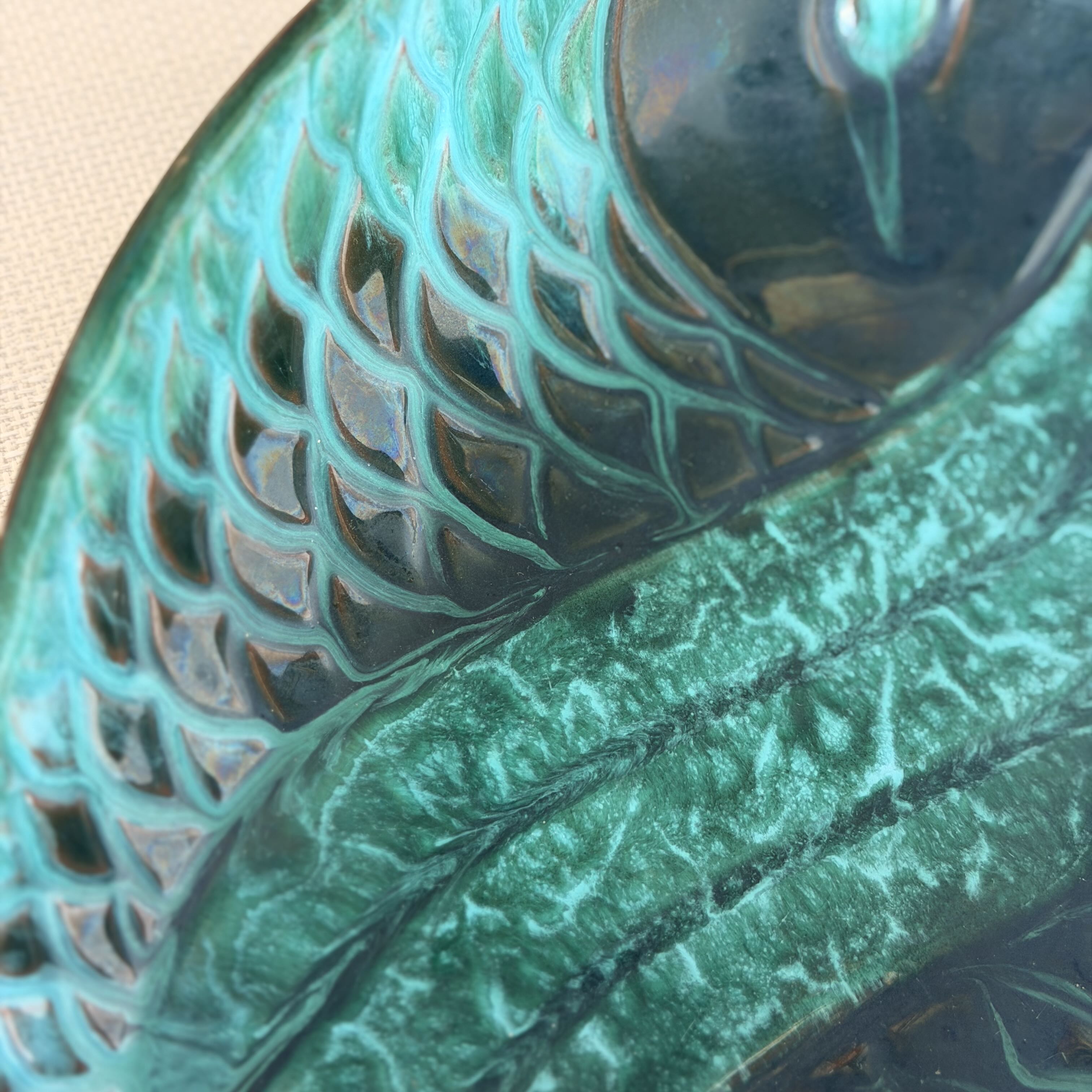 Close-up of a green ceramic dish with textured design