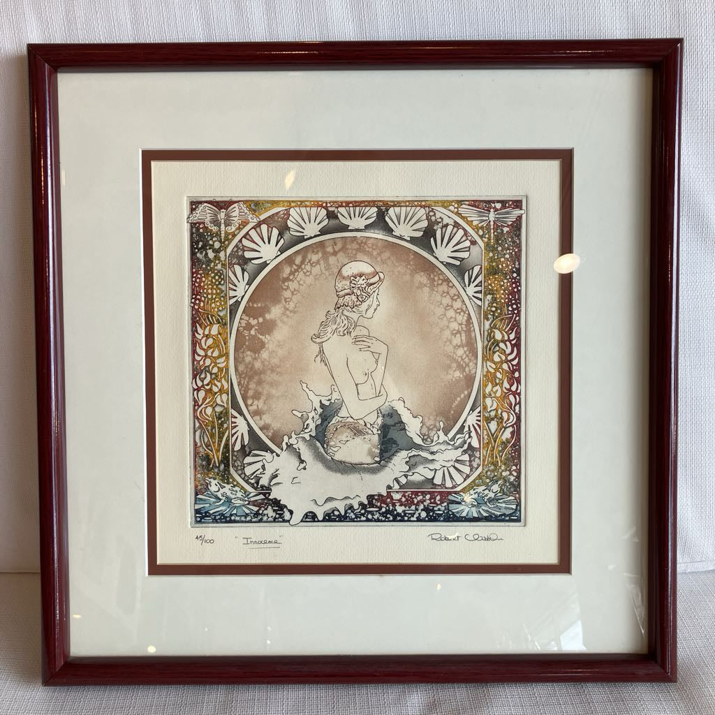 Framed artwork of a stylized figure with decorative elements on a plain background