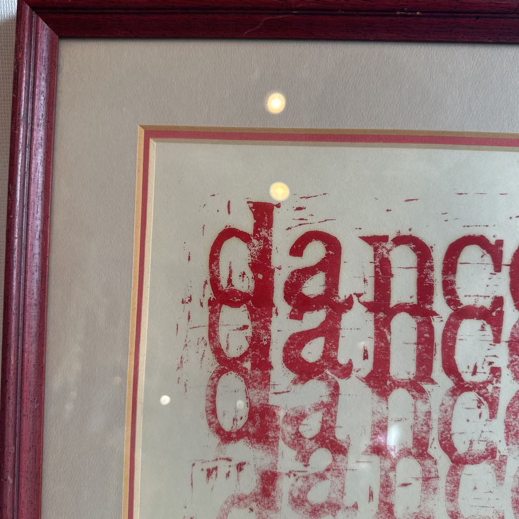 Framed artwork with the words dance in red.
