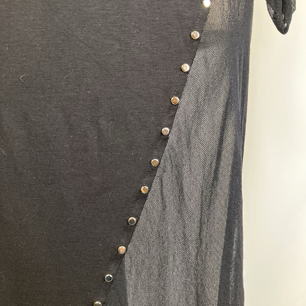 Close-up of a dark gray garment with gold buttons on a plain background