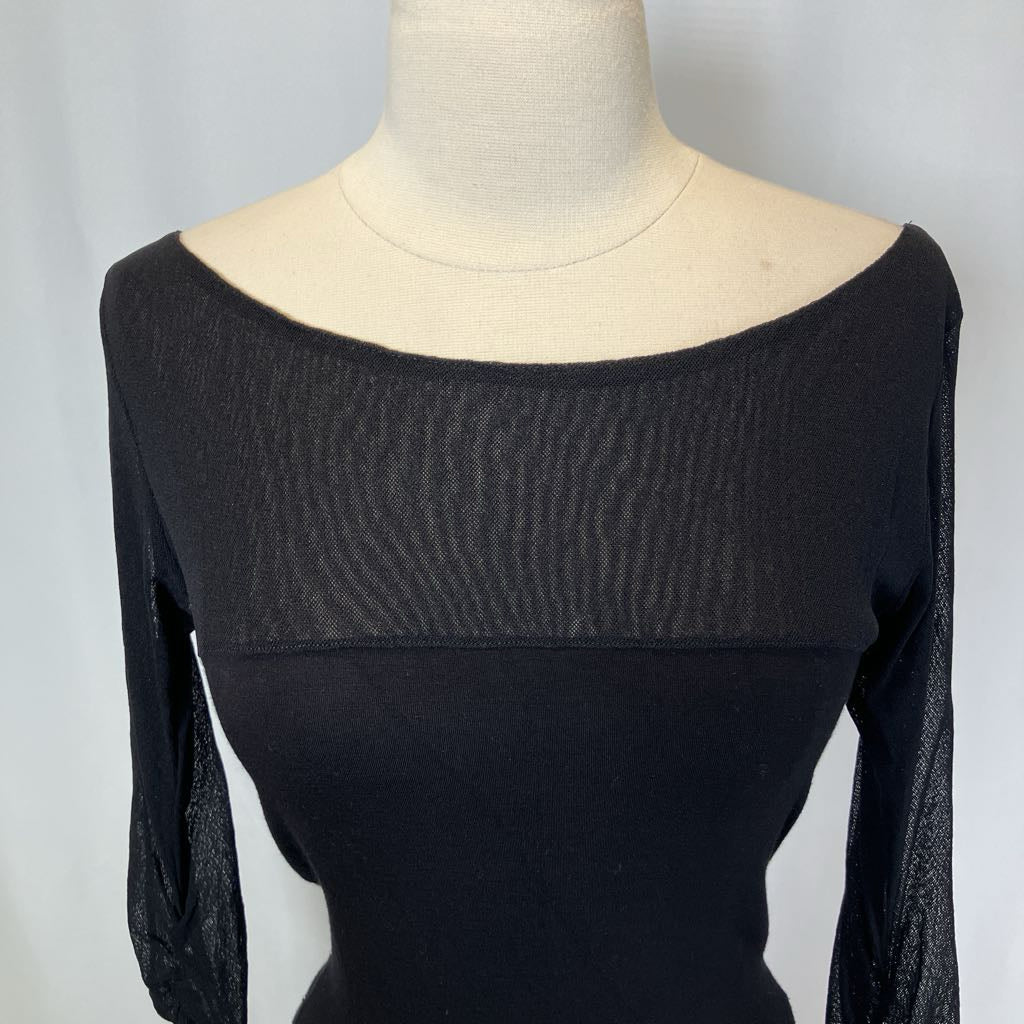 Black long-sleeve top on a mannequin against a plain background