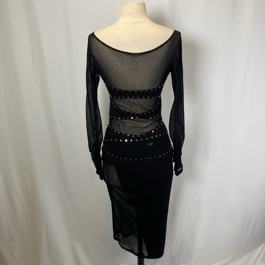Black dress with sheer overlay and embellishments on a mannequin against a plain background