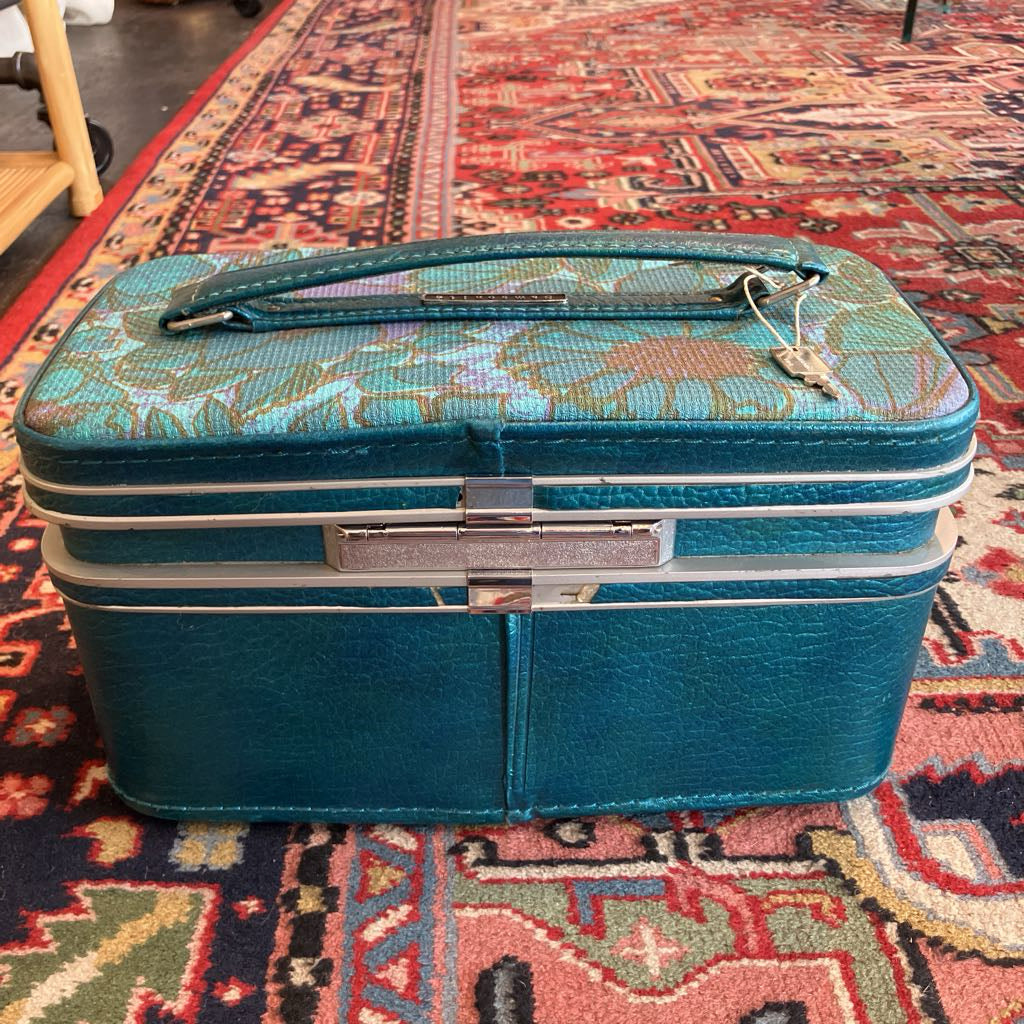Blue patterned suitcase on a colorful rug