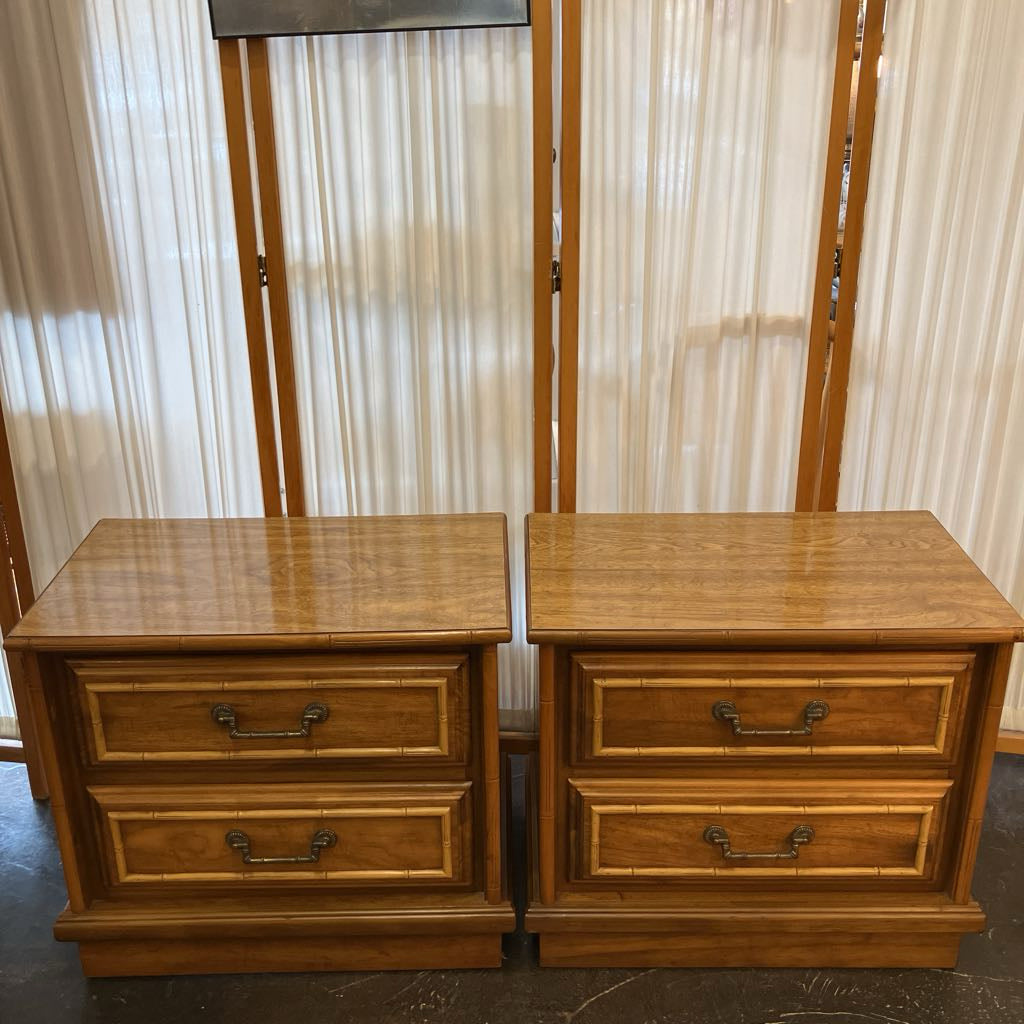 Two wooden nightstands with drawers against a neutral background