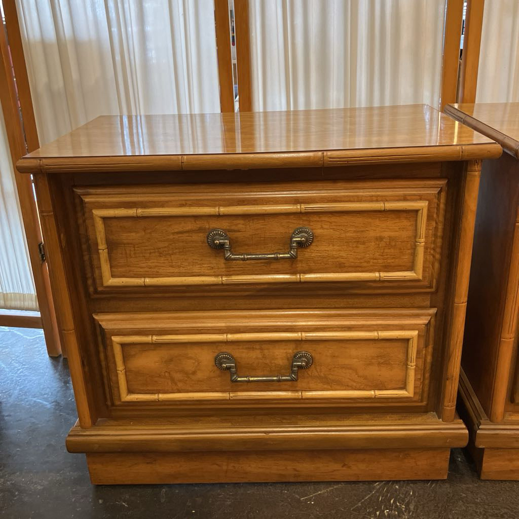 Wooden dresser with two drawers in a room with curtains.