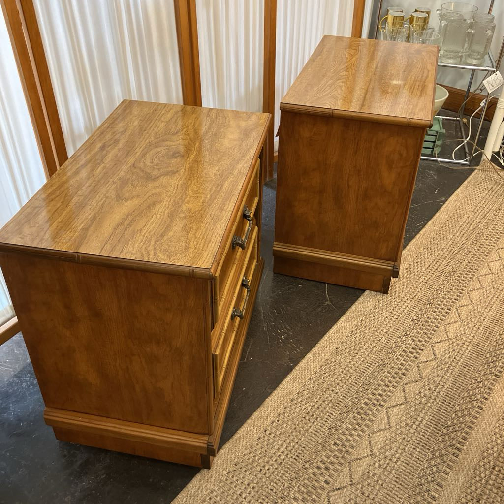 Two wooden nightstands seen from the side in a room setting.