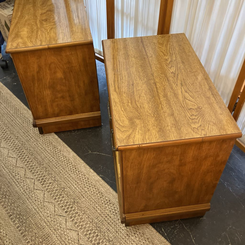 Two wooden nightstands seen from the side in a room setting.