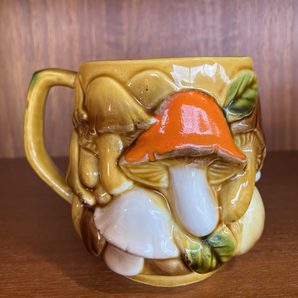 Mushroom-themed ceramic mug with a wooden background