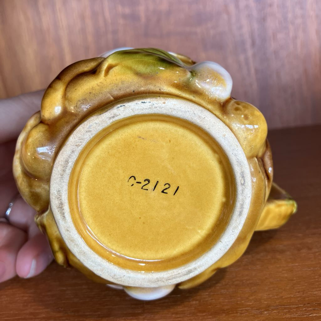 Ceramic item with a visible serial number on a wooden surface