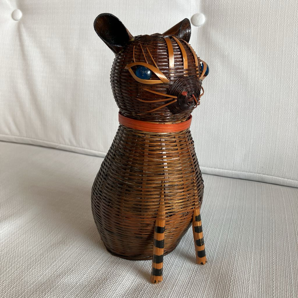 Wicker cat-shaped decorative item on a light-colored surface