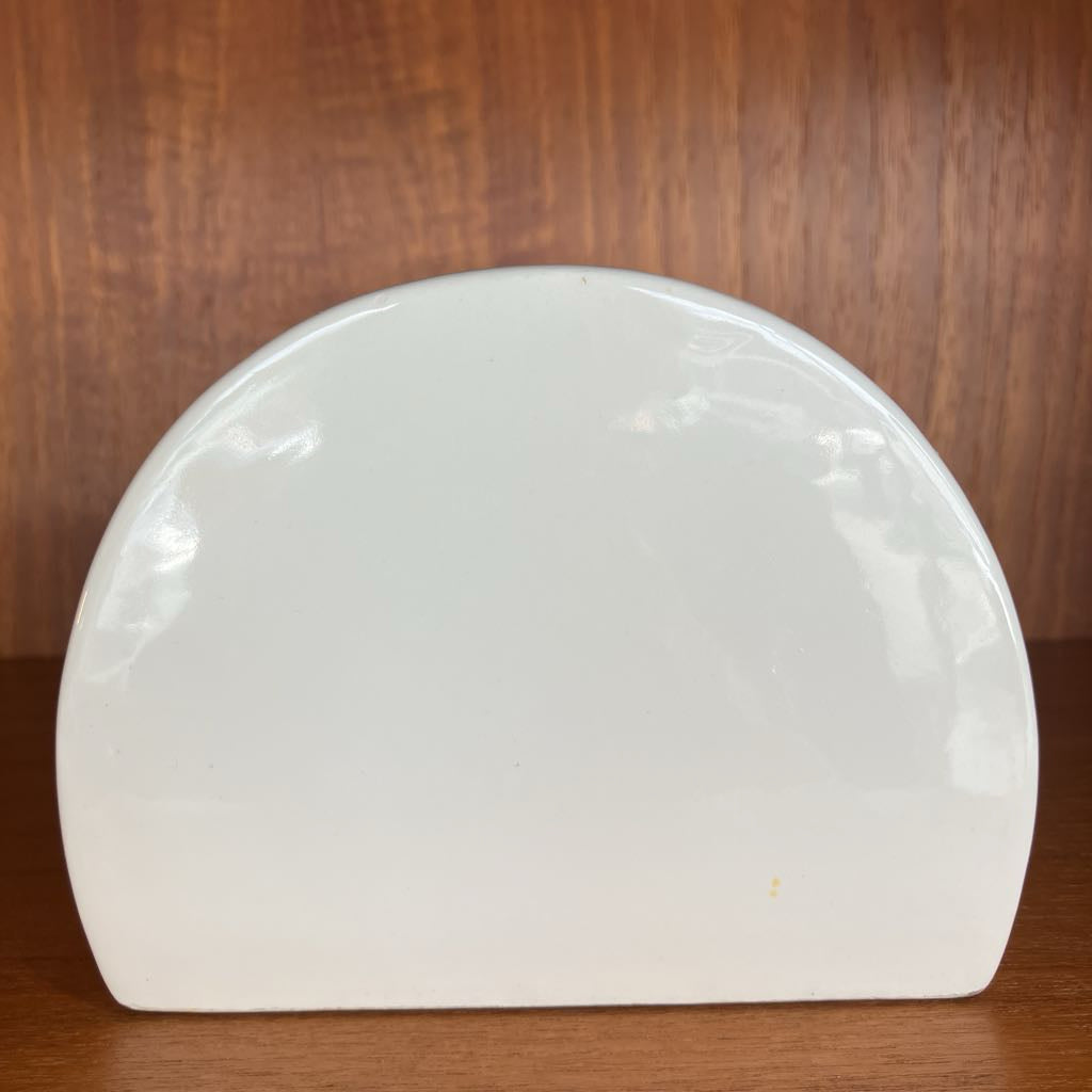 White ceramic object on a wooden surface
