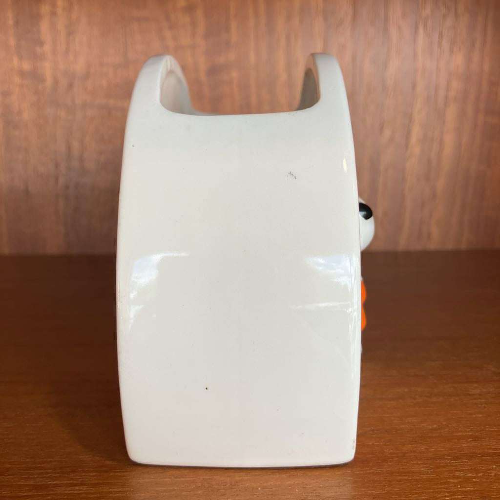 White ceramic object on a wooden surface