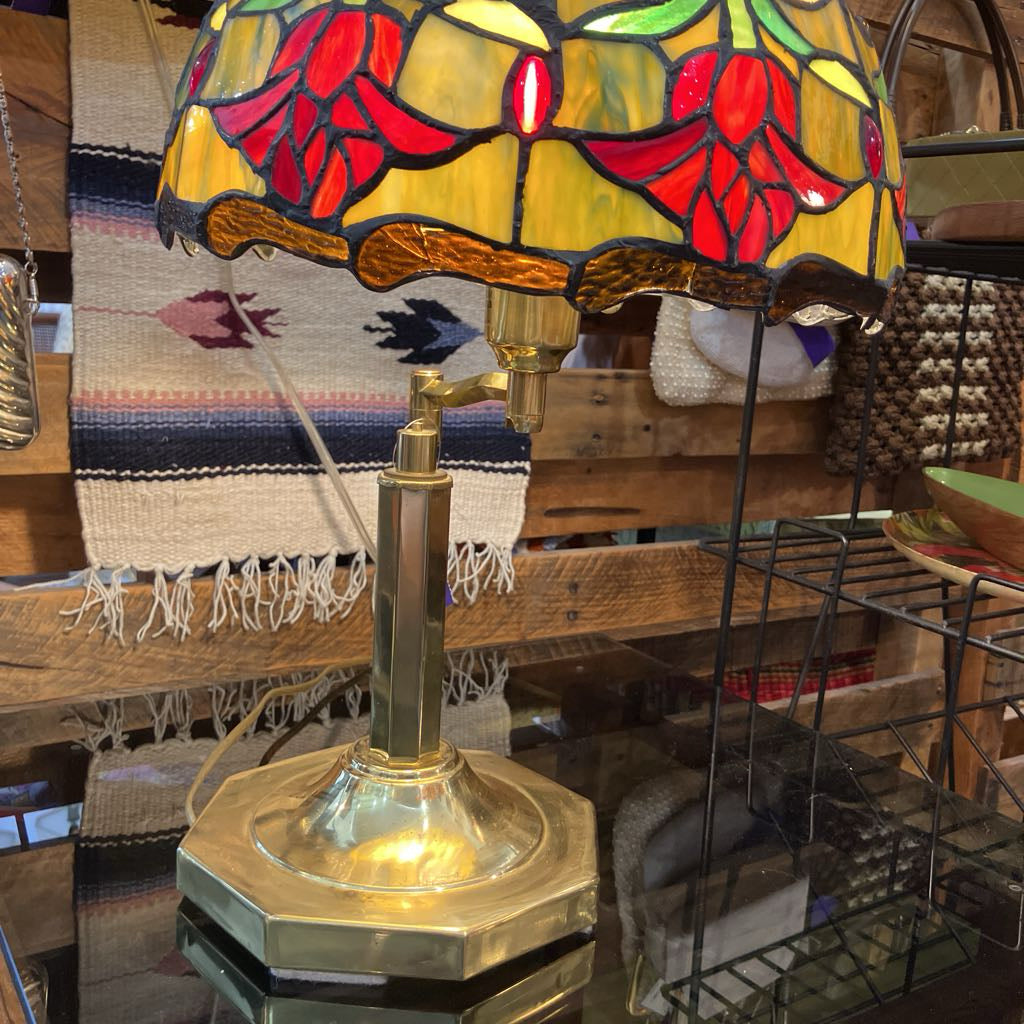 Stained glass lamp with floral design on a wooden surface