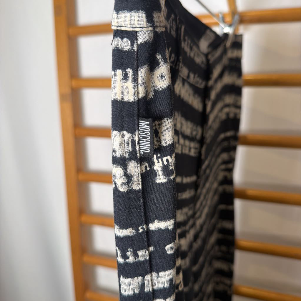 Black and white patterned towel hanging on a wooden rack.