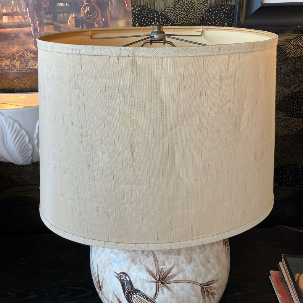 Lamp with a beige shade on a decorative base