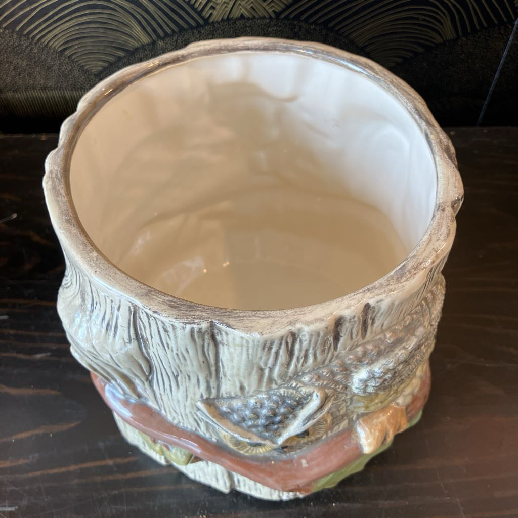 Ceramic pot with textured design on a dark surface