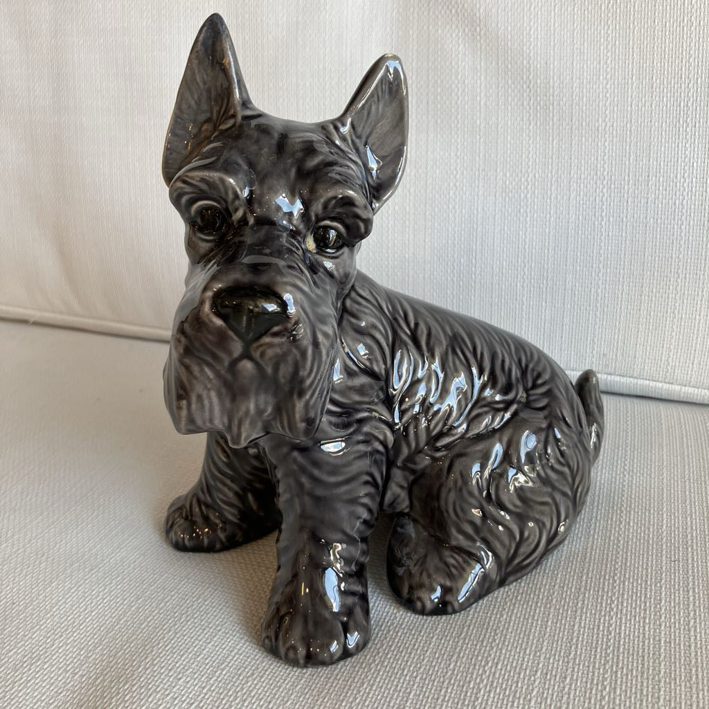 Ceramic figurine of a dog on a light-colored surface